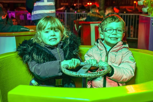 Christmas light switch on at Sutton Market Place. Pictured; Ella and Charlie enjoying a ride on the fair.