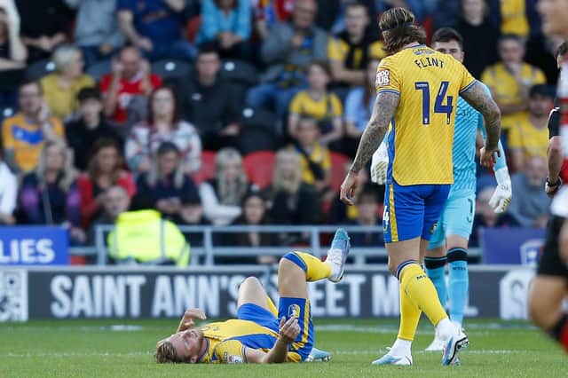 Aden Flint looks down with concern after a serious injury to defensive partner Alfie Kilgour at Doncaster. But the pair will reunite next season. 
Photo by Chris & Jeanette Holloway/The Bigger Picture.media