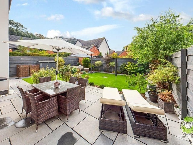 Moving outside now, here are a handful of exterior shots. This is a lovely patio area, sitting in the private and enclosed back garden, which also features a lawn of artificial turf.