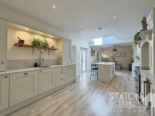 This outstanding space has been designed with both everyday family life and entertaining in mind, featuring a high-specification fitted kitchen complete with quartz work surfaces, a comprehensive range of quality integrated appliances, and a substantial central island providing both a practical workspace and an elegant social hub.