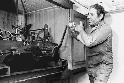 George Bird winds the clock above the Metal Box Factory in Mansfield in 1977.