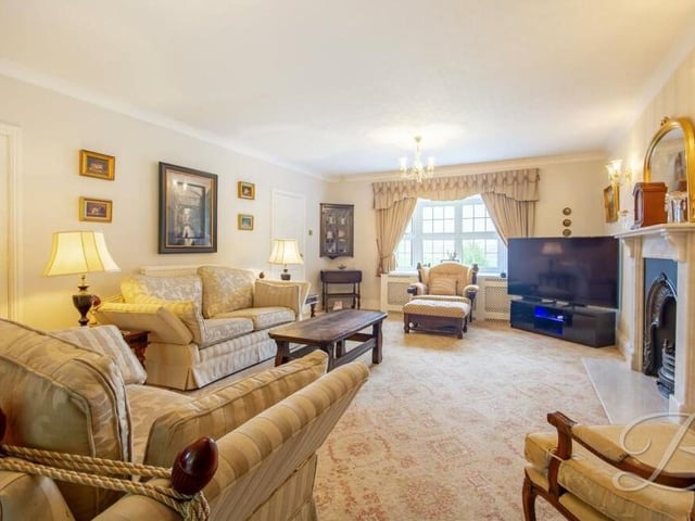 A second look at the lounge or living room, showing how bright and spacious it is. The floor is carpeted and there is coving to the ceiling, while the large bay window overlooks the front of the house.