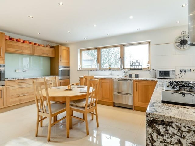 As you can see, the kitchen has lots of space for a breakfast or dining table. A range of wall cupboards, base units and drawers has solid oak door fronts, complemented by Brazilian quartz worktops.