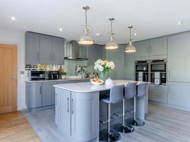 An impressive open plan kitchen/breakfast and living space with underfloor heating, featured a contemporary range of shaker cabinets with quartz work surfaces. There are a range of integrated AEG stainless steel cooking appliances to include twin ovens/grill and separate twin single ovens. Further integrated appliances include a fridge/freezer, dishwasher and wine cooler. The bi-fold doors lead out onto the substantial decked patio.