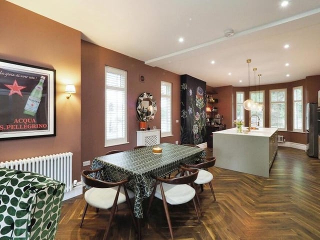 The bright and spacious kitchen extends into this living or dining area, where there is space for a breakfast table or dining table. Note how immaculately presented everything is.