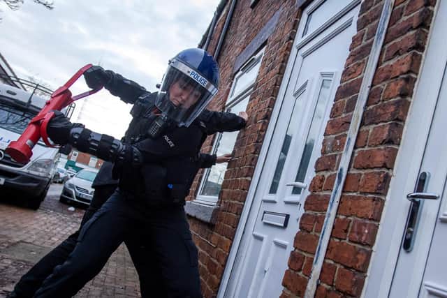Police raid a property in Sutton.