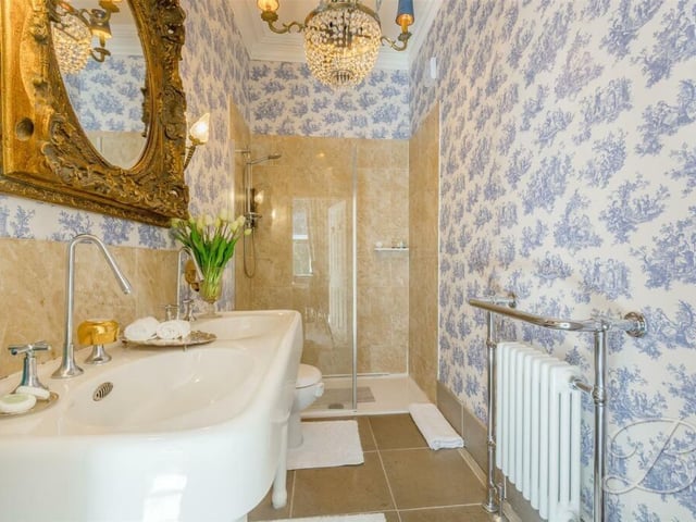 One of the first-floor bedrooms has its own excellent en suite. It includes a walk-in shower cubicle, double hand wash basin, low-flush WC and central heating radiator.