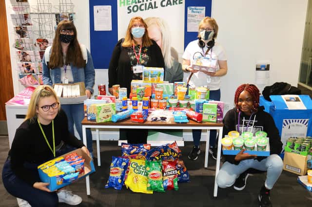 Louisa Hillman, manager of The Beacon Project, (centre back) with health and social care students' generous hampers