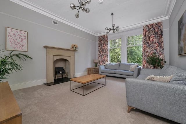 Let's launch our photo gallery of Norfolk House with the first of two large, south-facing reception rooms, the elegant lounge. It features a stunning stone fireplace, which was rescued from a Grade I listed vicarage in north Yorkshire and contains a slate hearth and inset open fire.