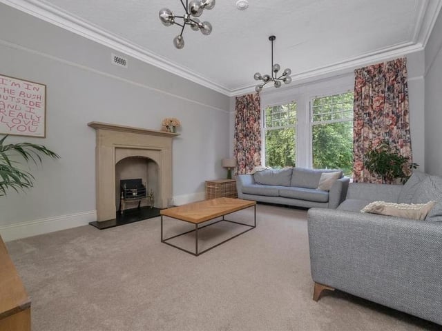 Let's launch our photo gallery of Norfolk House with the first of two large, south-facing reception rooms, the elegant lounge. It features a stunning stone fireplace, which was rescued from a Grade I listed vicarage in north Yorkshire and contains a slate hearth and inset open fire.