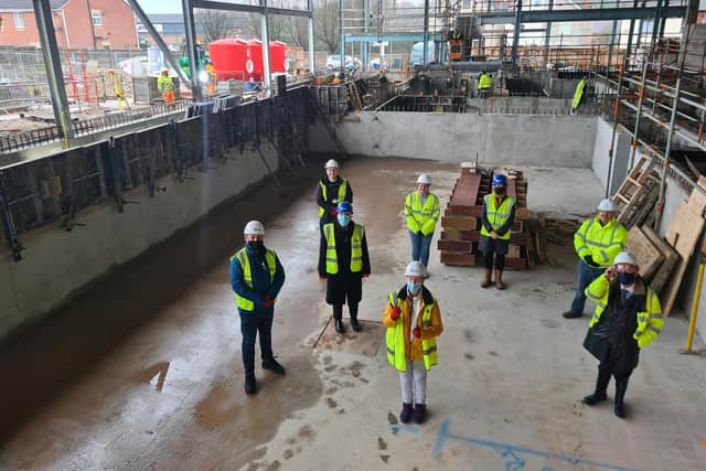 Ashfield District councillors stand in the new swimming pool which is currently under construction