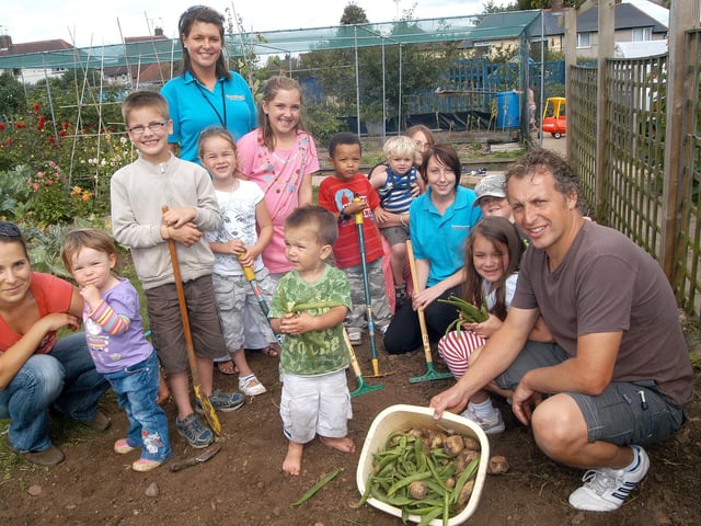 Surestart's Toni Selby and Stacey Clarke with Little Roots' allotment co-ordinator Richard Tucker pictured with visitors at the Slant Lane garden, in Mansfield Woodhouse, where a barbecue, tombola and cake stall was set up to raise funds for the allotment project.