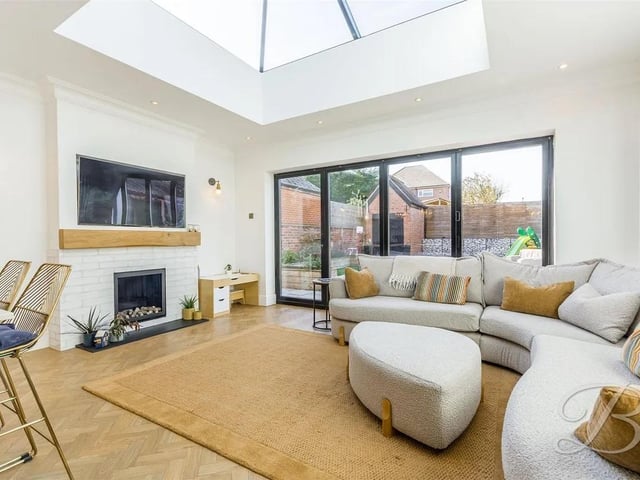 The room is further enhanced by a skylight and bi-folding doors that open seamlessly into the rear garden, providing a perfect indoor-outdoor flow.