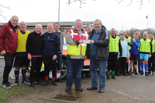 Silvano Taylor of Mansfield Senior Reds Walking Football Club presenting a cheque for £400 to John McFadden of Notts Blood Bikes. Pic by Richard Parkes.