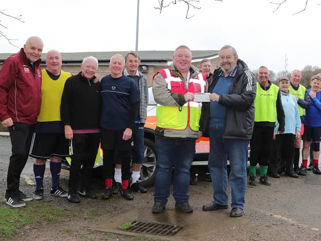 Silvano Taylor of Mansfield Senior Reds Walking Football Club presenting a cheque for £400 to John McFadden of Notts Blood Bikes. Pic by Richard Parkes.