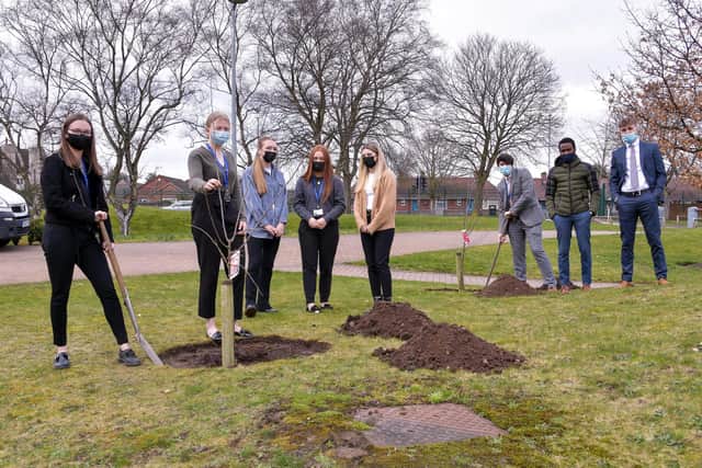 Students Millie Johnson, Alysha Bowles, Lily-Rose Stafford, Grace O'Neill, Lily Ridge, Kieran Walker, Alpha Bah and Ben Blythe plant trees in the grounds of Samworth Church Academy.