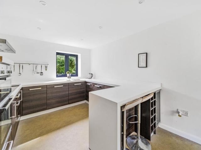 An attractive feature of the kitchen is its stylish breakfast bar, perfect for enjoying a morning coffee or casual meals.