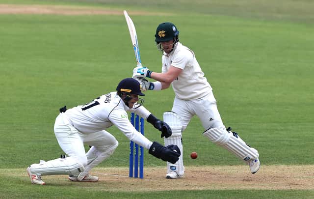 Tom Moores pulls the ball as Warwickshire wicket keeper Michael Burgess attempts a catch. (Photo by David Rogers/Getty Images)