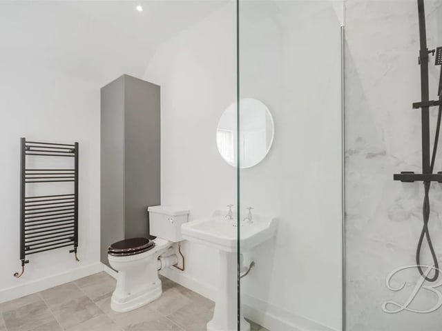 This annex features an ensuite and separate bathroom. The unique property offers versatile living space ideal for multigenerational living.