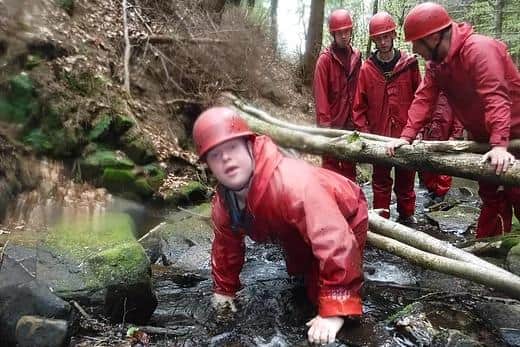 A youngster taking part in a gorge scramble during an Adventure Service expedition.
