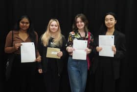 Ashmini, Scarlett, Olivia and Lily with their GCSE results letters.