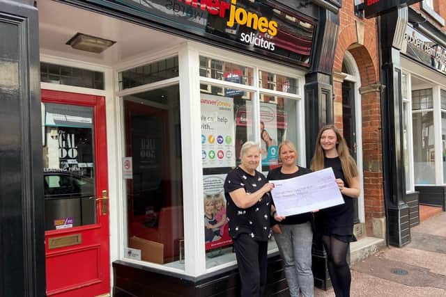 Jane Tweedy receives the donation from Banner Jones representatives. (Photo by: Banner Jones)
