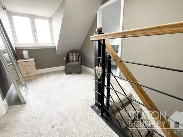 As we reach the second floor, here is the upper landing, with seating area, that leads to the master bedroom.