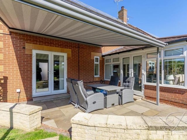The delightful back garden also features this covered patio seating area. A perfect spot for entertaining family and friends at weekends.