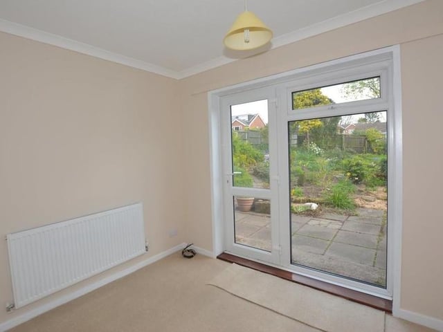 Completing our inspection of the ground floor is this compact bedroom, which could be used as an office instead. A double-glazed uPVC door opens out on to the back garden..