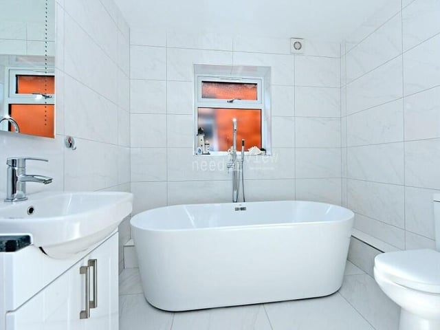 Before we have a look outside, let's take a peek at the contemporary family bathroom. A four-piece suite consists of a free-standing bath, separate shower cubicle, wash hand basin built into a vanity unit, and WC. There is also a chrome towel radiator and a ceiling light point.,