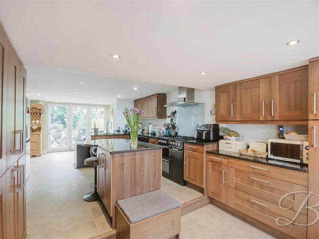 A spacious open-plan kitchen, dining, and sitting area designed for both everyday living and entertaining.