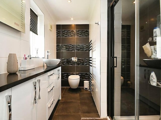 It'd hard to imagine a more immaculate en suite bathroom than this one, attached to the master bedroom. It features a shower cubicle, wash hand basin, low-flush WC and lots of storage space.
