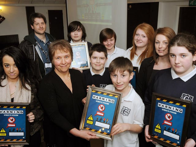 Barbara Brady, a consultant in Public Health for Nottinghamshire, presents Kirkby College pupil Brendan Arnold, with a framed certificate after he and other students made a short film to launch a competition on substance abuse. Also pictured are Joel Ball, Sophie Hill, Helena Lloyd, Hannah King, Ruby Barnfather and Jake Yeatman, with teacher Samantha Melvin and Tim Smith from Fourmost Films.