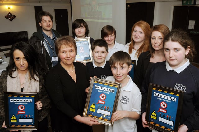 Barbara Brady, a consultant in Public Health for Nottinghamshire, presents Kirkby College pupil Brendan Arnold, with a framed certificate after he and other students made a short film to launch a competition on substance abuse.  Also pictured are Joel Ball, Sophie Hill, Helena Lloyd, Hannah King, Ruby Barnfather and Jake Yeatman, with teacher Samantha Melvin and Tim Smith from Fourmost Films.