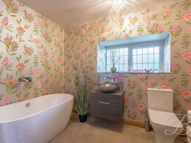 The property's family bathroom is an attractive space. It features a free-standing bath, low-flush WC and wash hand basin. Like all the rooms, it is beautifully presented.