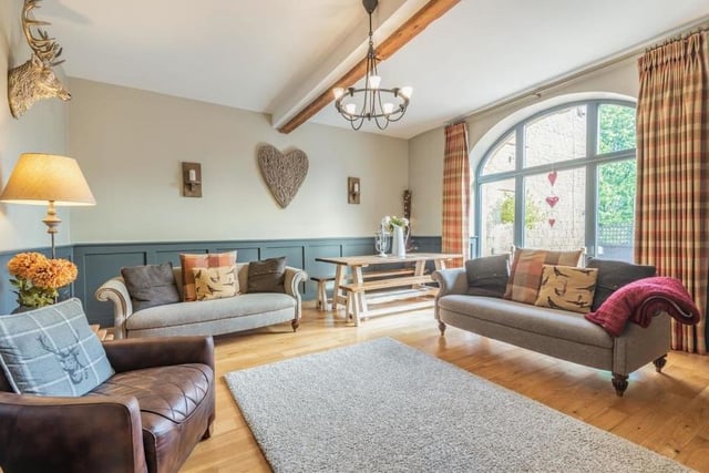 The ground floor of the barn conversion consists mainly of an open-plan kitchen/diner and this stunning lounge. It's bright and airy thanks to a large, feature, arched, double-glazed window overlooking the front of the property.