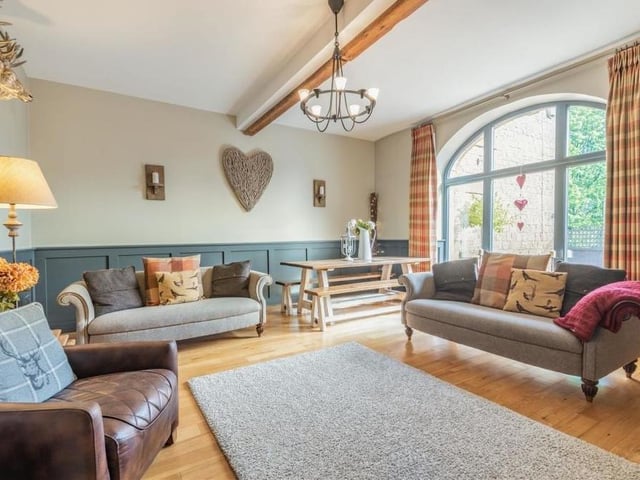 The ground floor of the barn conversion consists mainly of an open-plan kitchen/diner and this stunning lounge. It's bright and airy thanks to a large, feature, arched, double-glazed window overlooking the front of the property.