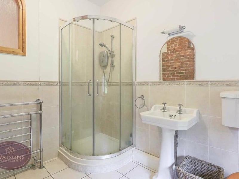 Here is a closer look at the en suite shower room to the main bedroom, complete with shower cubicle.