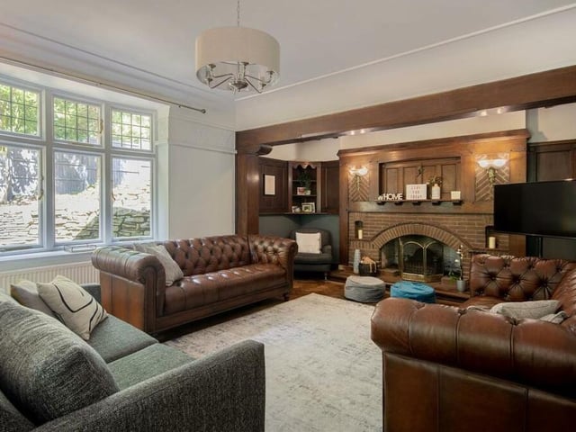 The living room at the Norfolk Drive mansion is bright as well as spacious. A big bay window overlooks the side of the house, while French doors lead to a sun room.
