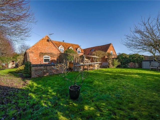 This wonderful barn conversion is surrounded by peaceful, unspoiled countryside. The gardens extend to the side and rear, featuring a walled courtyard, a lawn, and a paved patio with a central water feature. An additional piece of land, measuring approximately 190m2, sits adjacent to the front of the property.