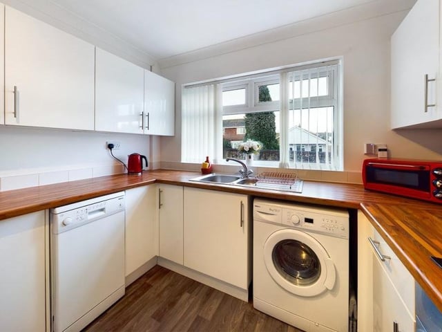 A final look at the kitchen, which is fitted with, or has space and plumbing for, essential appliances. The window offers views of the front of the property.