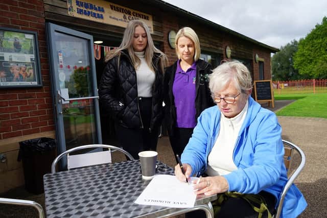 A customer signs the petition to help save the cafe from closure.