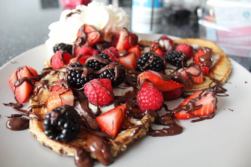 Protein pancakes with dark chocolate, fruit and cream.