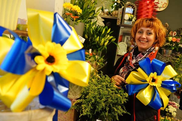 Marie Carline, owner of Bolsover Flowers, with one of her sunflower bows to help the people of Ukraine. Picture by Brian Eyre.