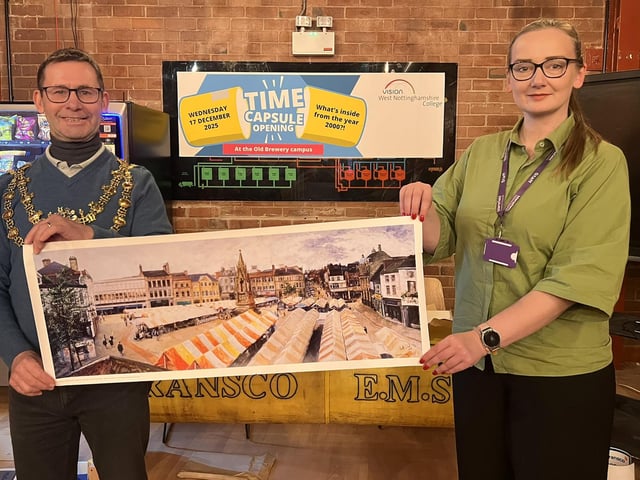 Mayor Andy Abrahams and his PA Anna Panfill with a print of the marketplace, set to go into the new capsule.