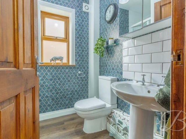 The ground floor also contains this stylish shower room, complete with enclosed shower, low-flush WC and pedestal sink.