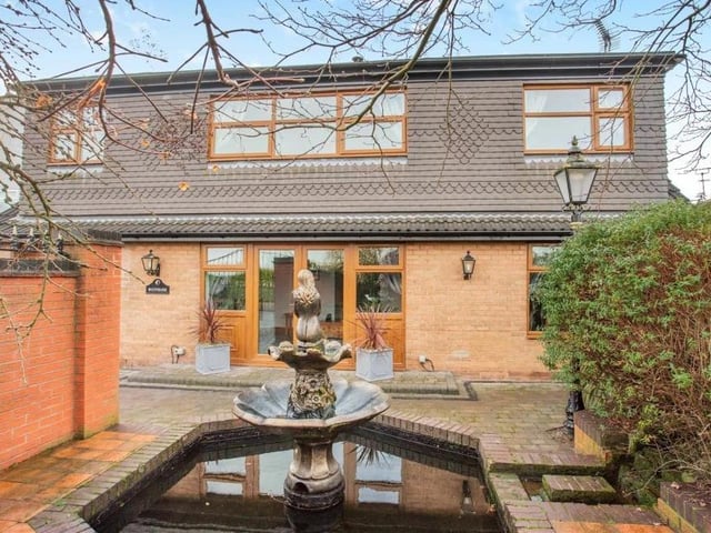 Let's move outside now and return to the front of the house. The garden has been fully landscaped to provide a highly usable space that includes a central water feature and paved pathways