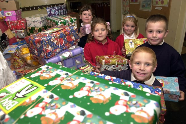 Pupils Emily Firbank, aged seven,  Ellana Storr, Meghan Hughes, Jacob Bailey, all aged six, and Callum Moses, aged five, are pictured with some of the shoeboxes in 2002