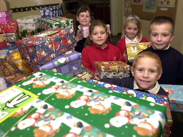 Pupils Emily Firbank, aged seven,  Ellana Storr, Meghan Hughes, Jacob Bailey, all aged six, and Callum Moses, aged five, are pictured with some of the shoeboxes in 2002
