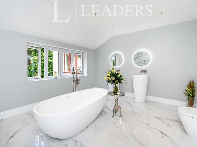 The family bathroom on the first floor has been re-fitted to a fantastic standard, with free-standing bath, walk-in double shower enclosure, two feature floor-standing wash hand basins and marble-effect floor tiles.